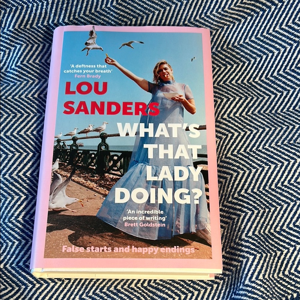 Lou Sanders 'What's That Lady Doing?' Book - Pink Cover